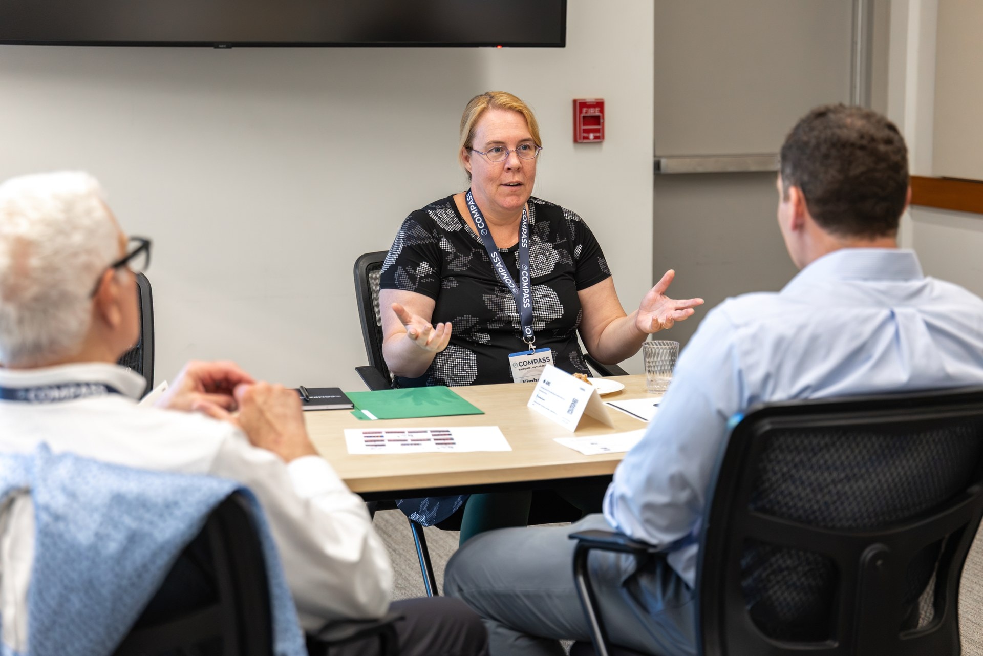 A researcher talking through her technology with investors at a Waypoints meeting table