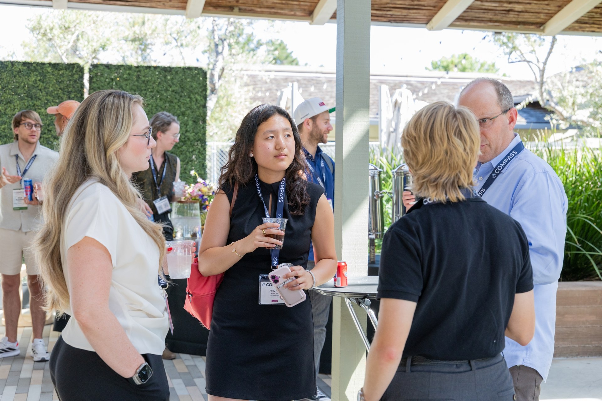 Attendees talking on the patio during the reception